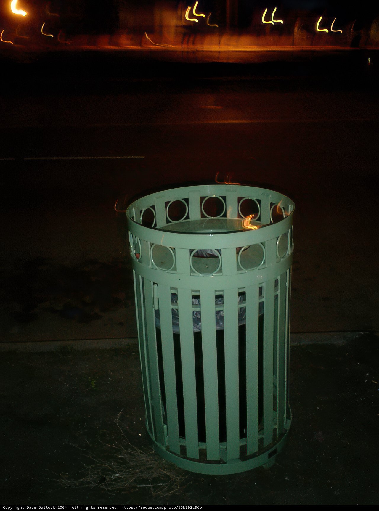 Tin Trash Can on Night Sidewalk