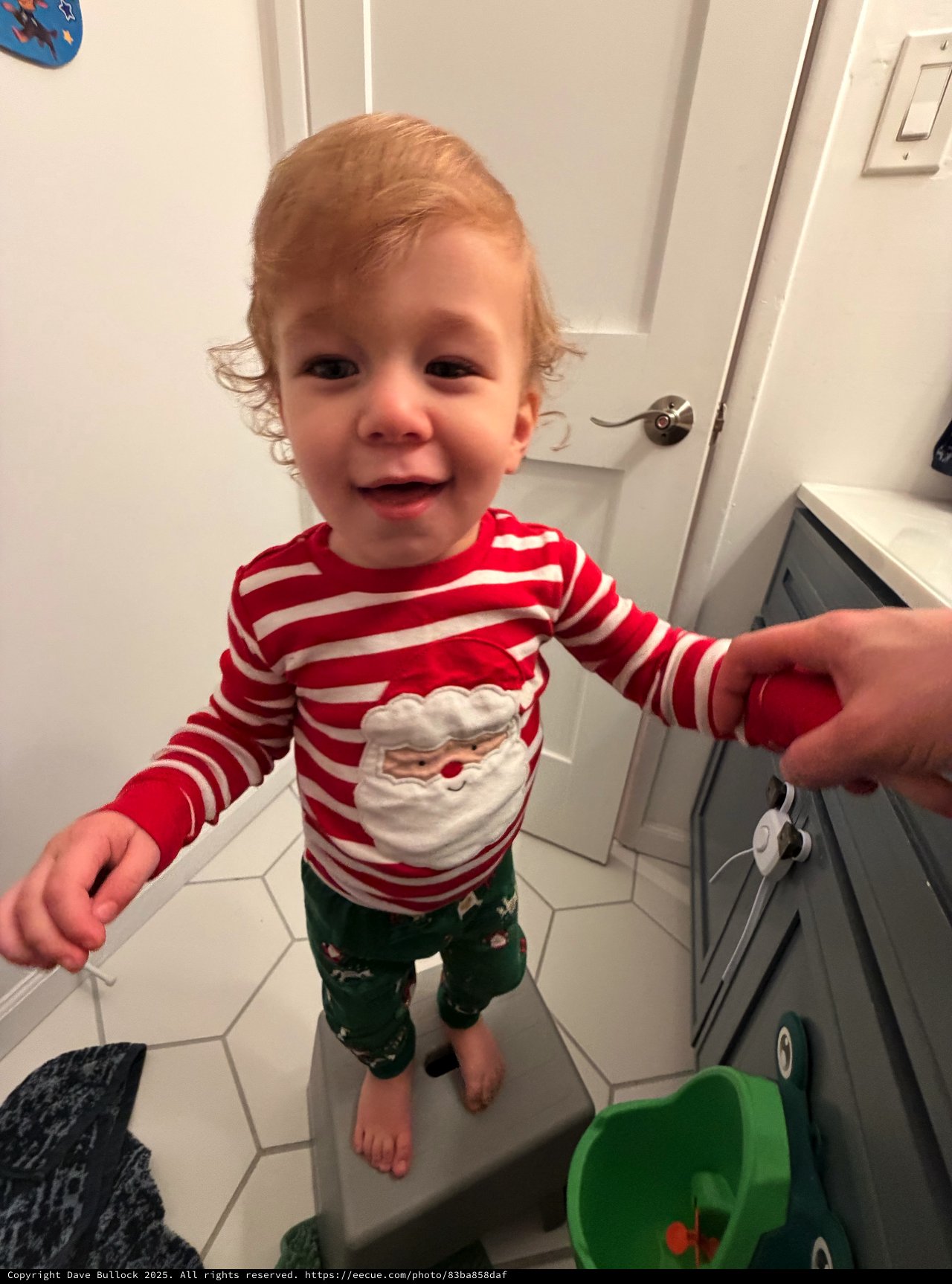 Toddler in Festive Christmas Pajamas in Bathroom