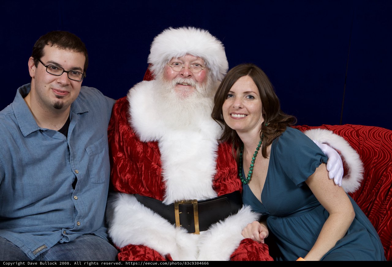 Adults Posing with Santa at Christmas Party 2008