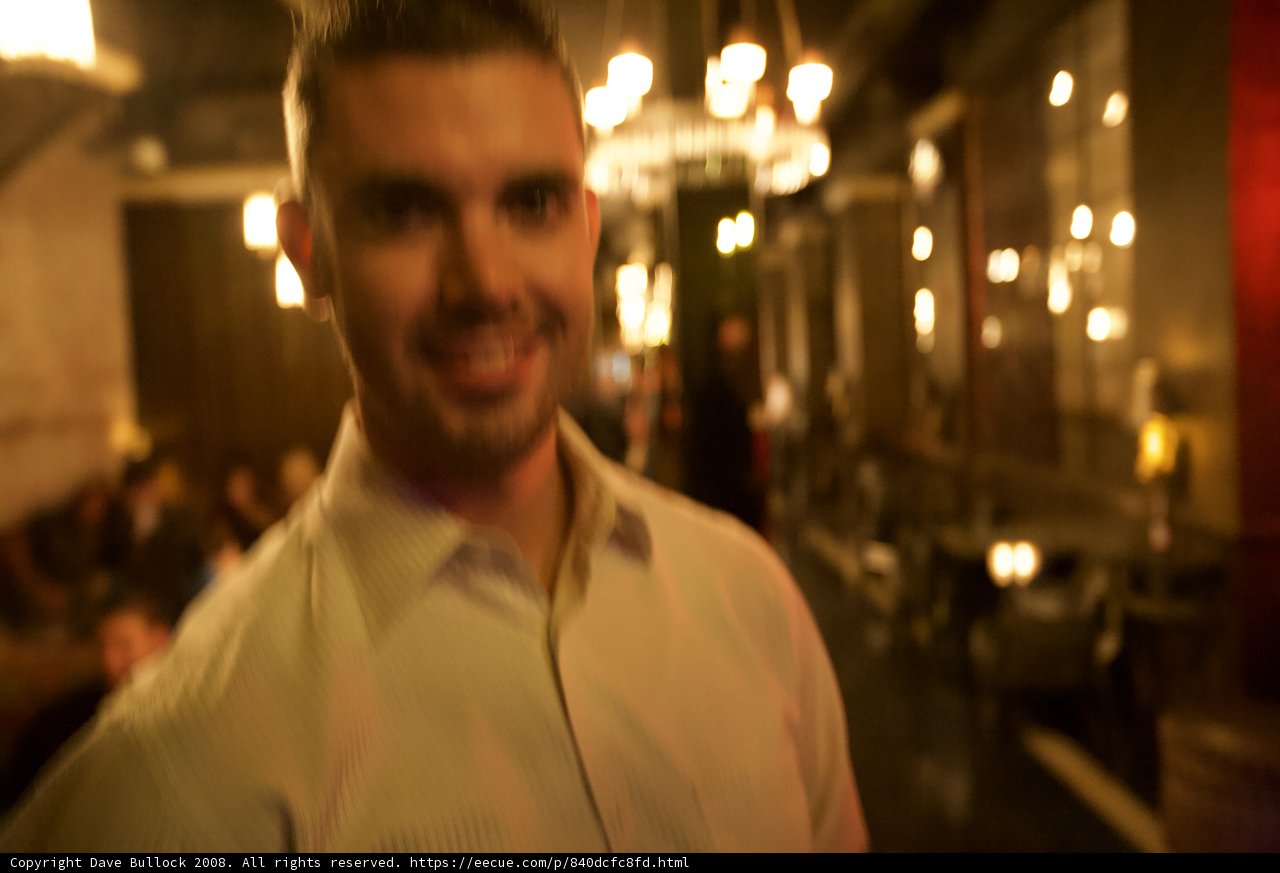 Smiling Man with White Shirt in Pub