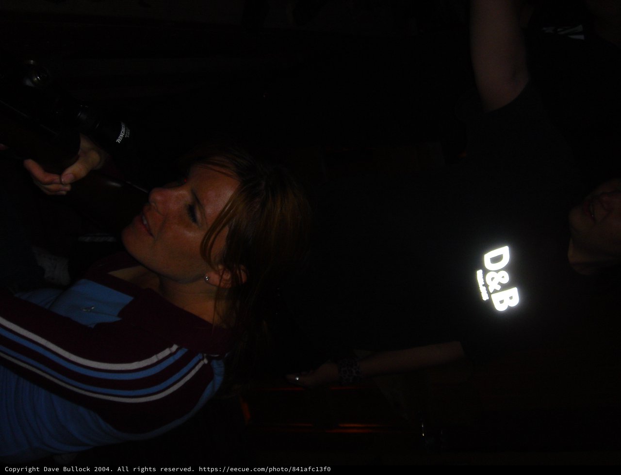 Woman Laughing in Dark Nightclub Setting