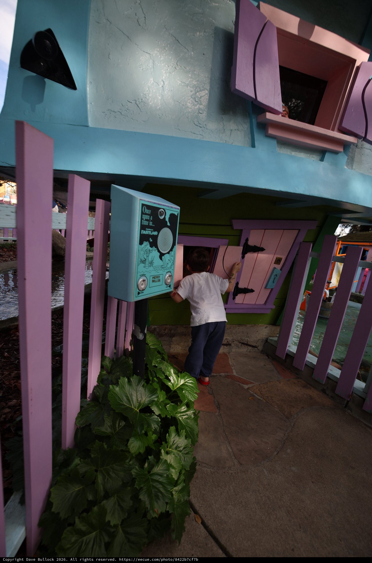 Child Exploring Interactive Installation at Whimsical Waterside Pavilion