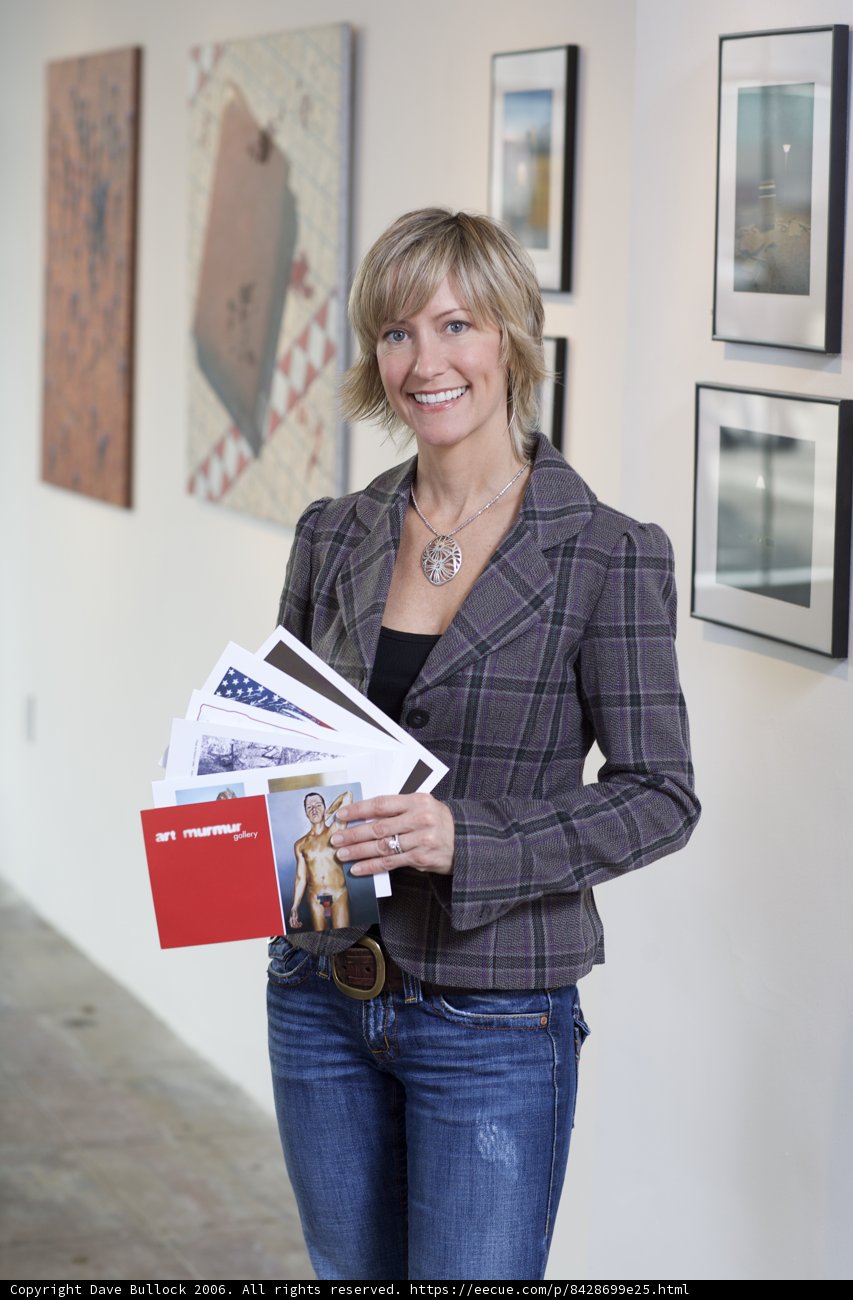 Woman with Folder in front of Artwork