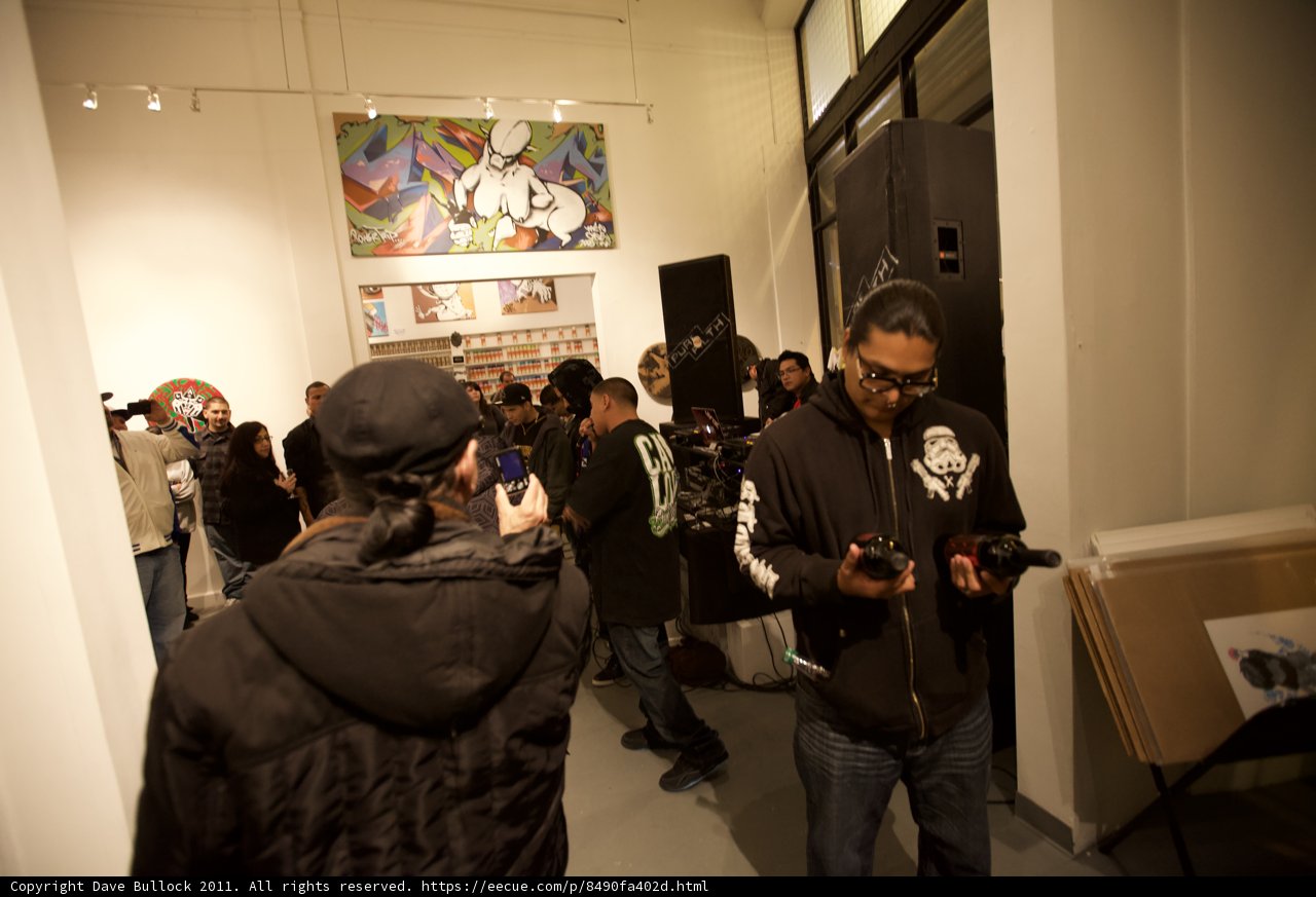 Man in Coat Addresses a Crowd at Plata Wine Party