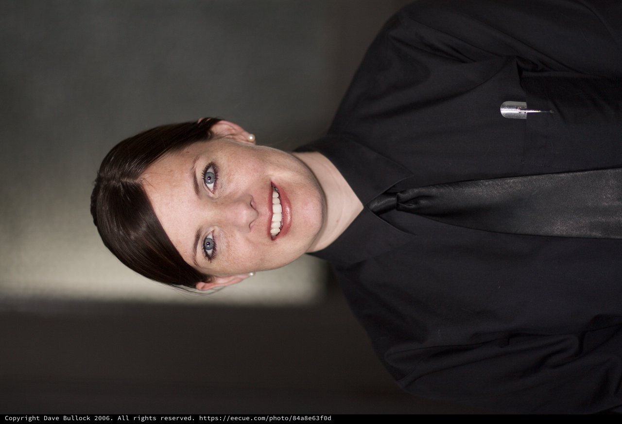 Professional Portrait of Smiling Woman in Black Uniform
