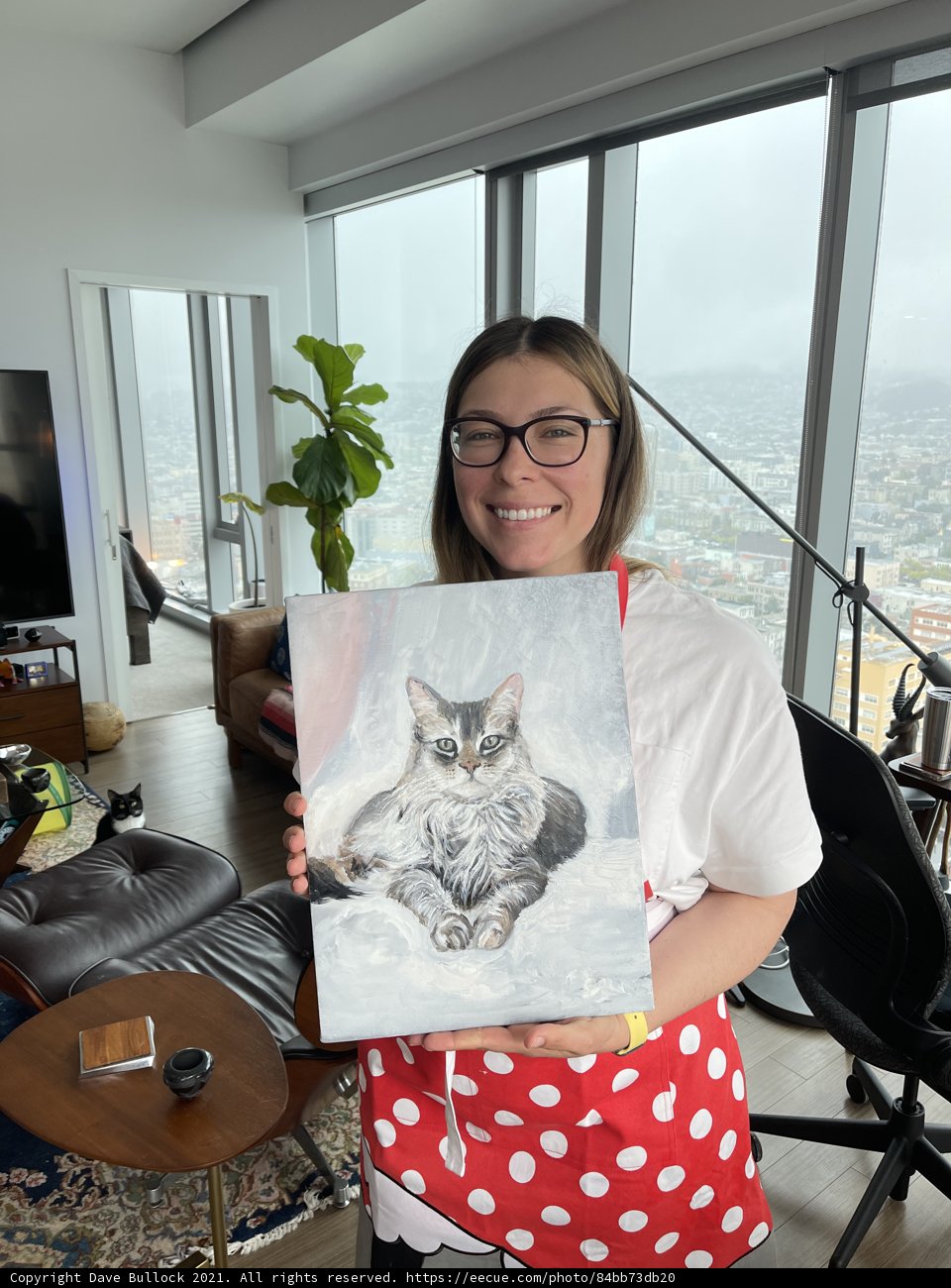 Woman Holds Beautiful Painting of a Cat in Living Room