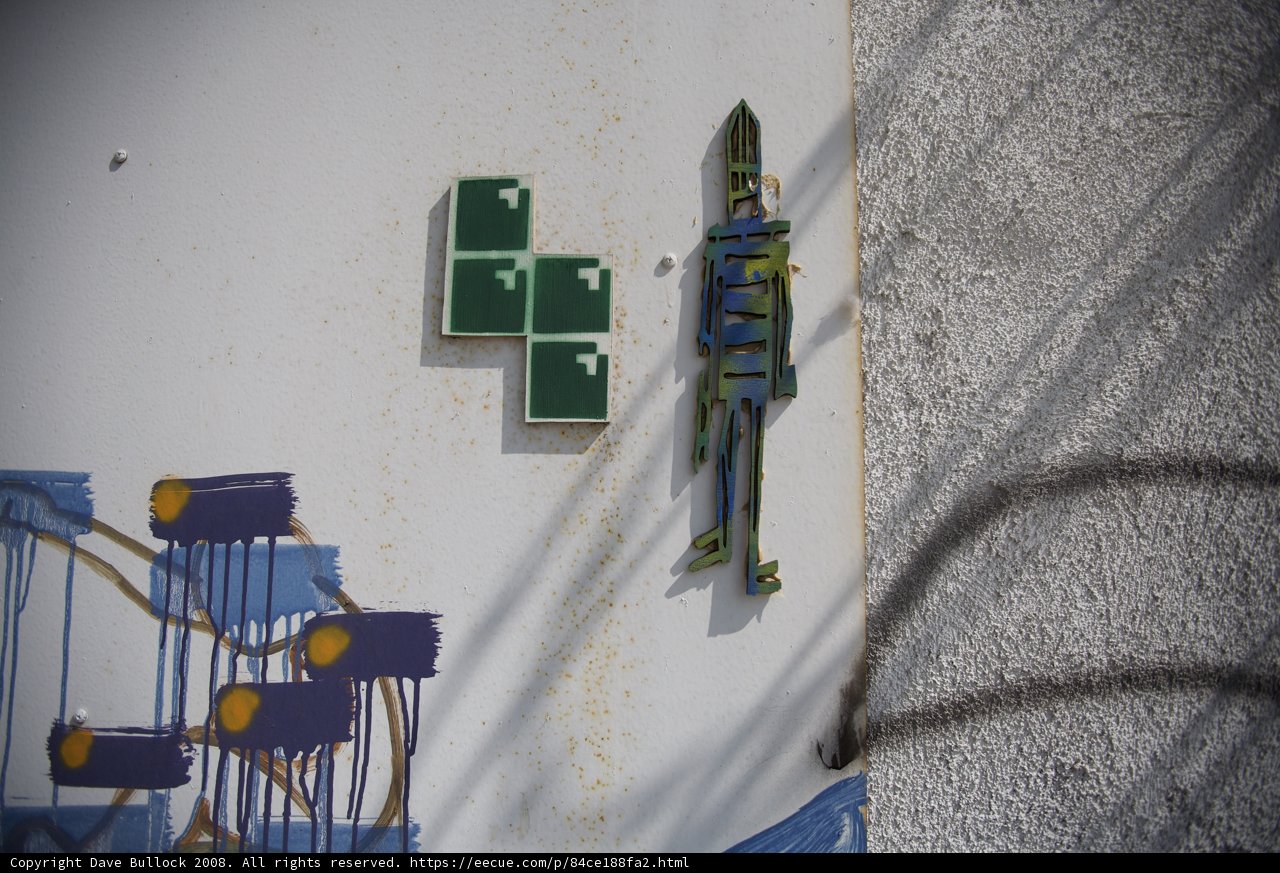 Cross and Symbol Graffiti on a Building Wall