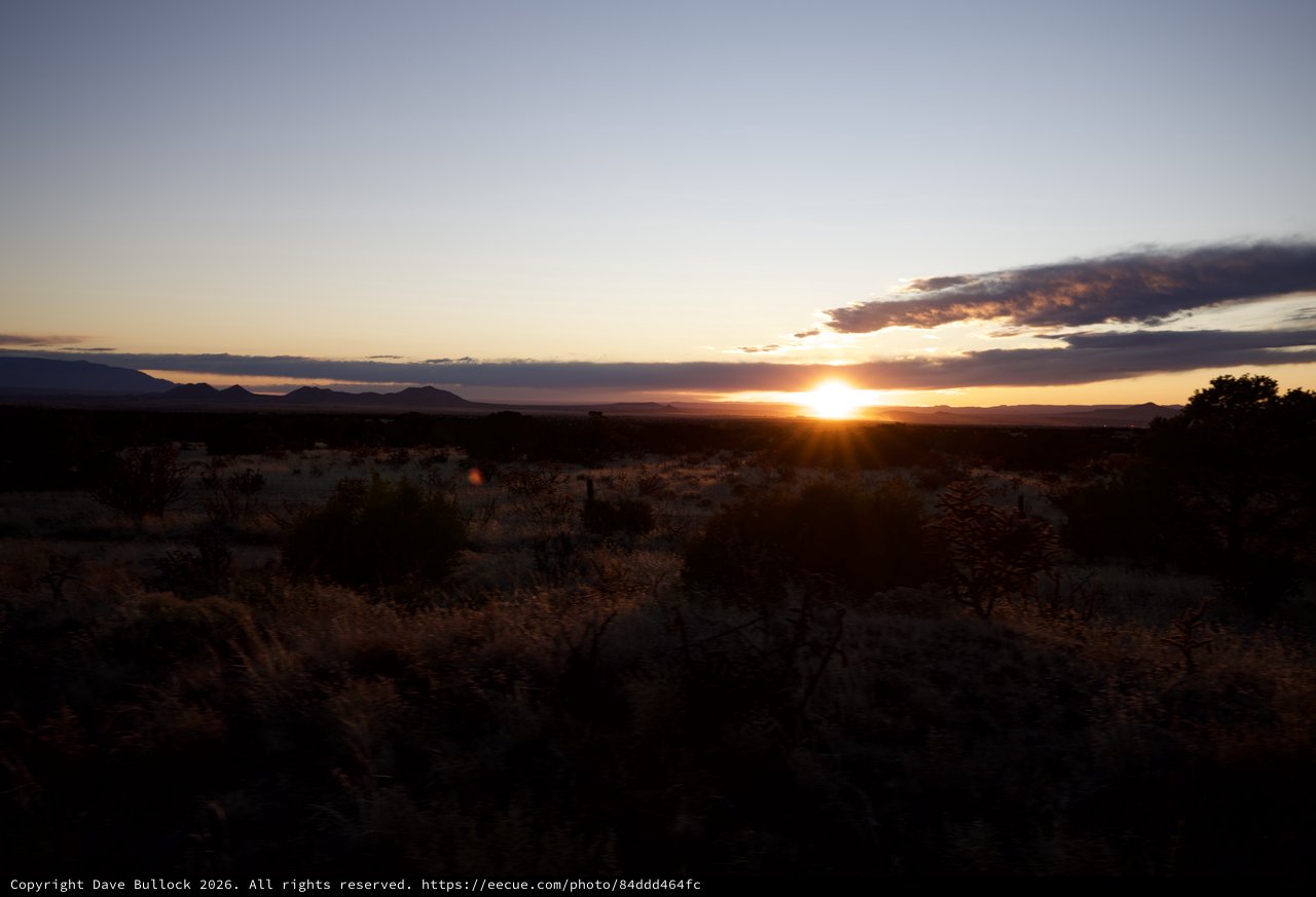 Desert Sunset Over Distant Mountain Ranges