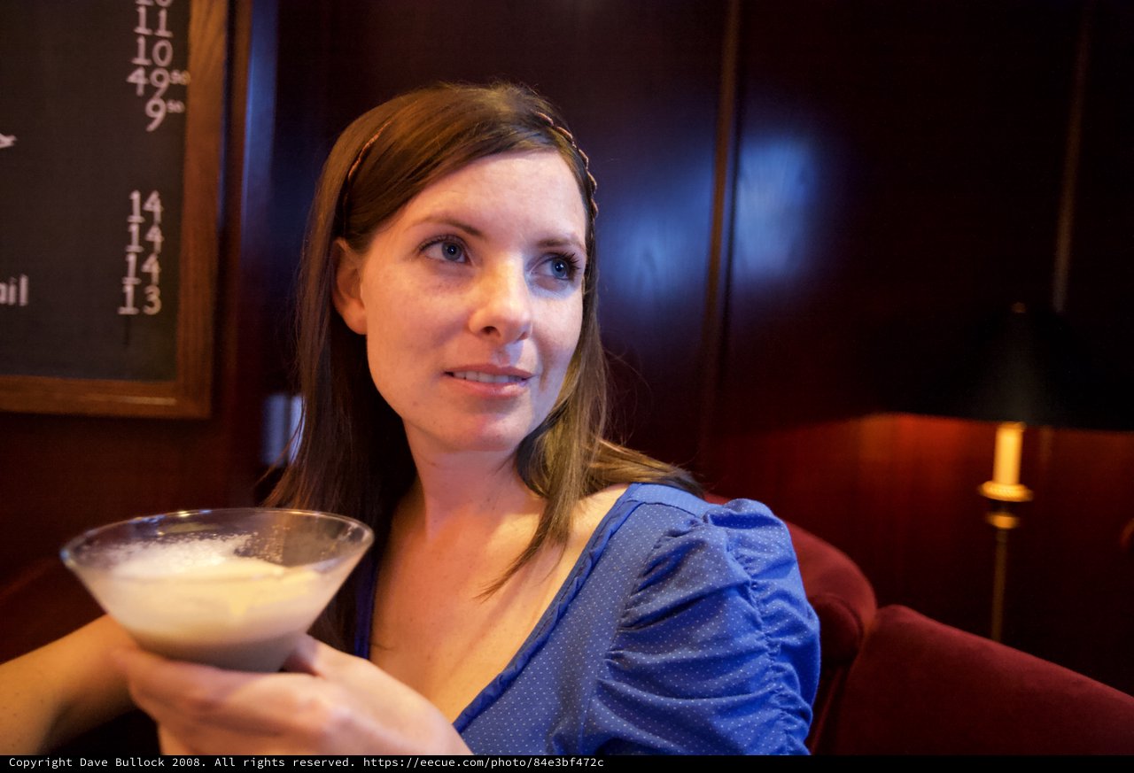 Woman Relaxing with Cocktail in Upscale Bar