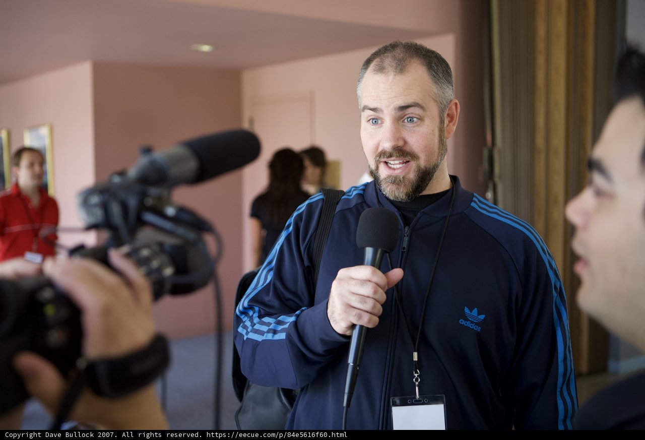 Man with Microphone Addresses the Camera