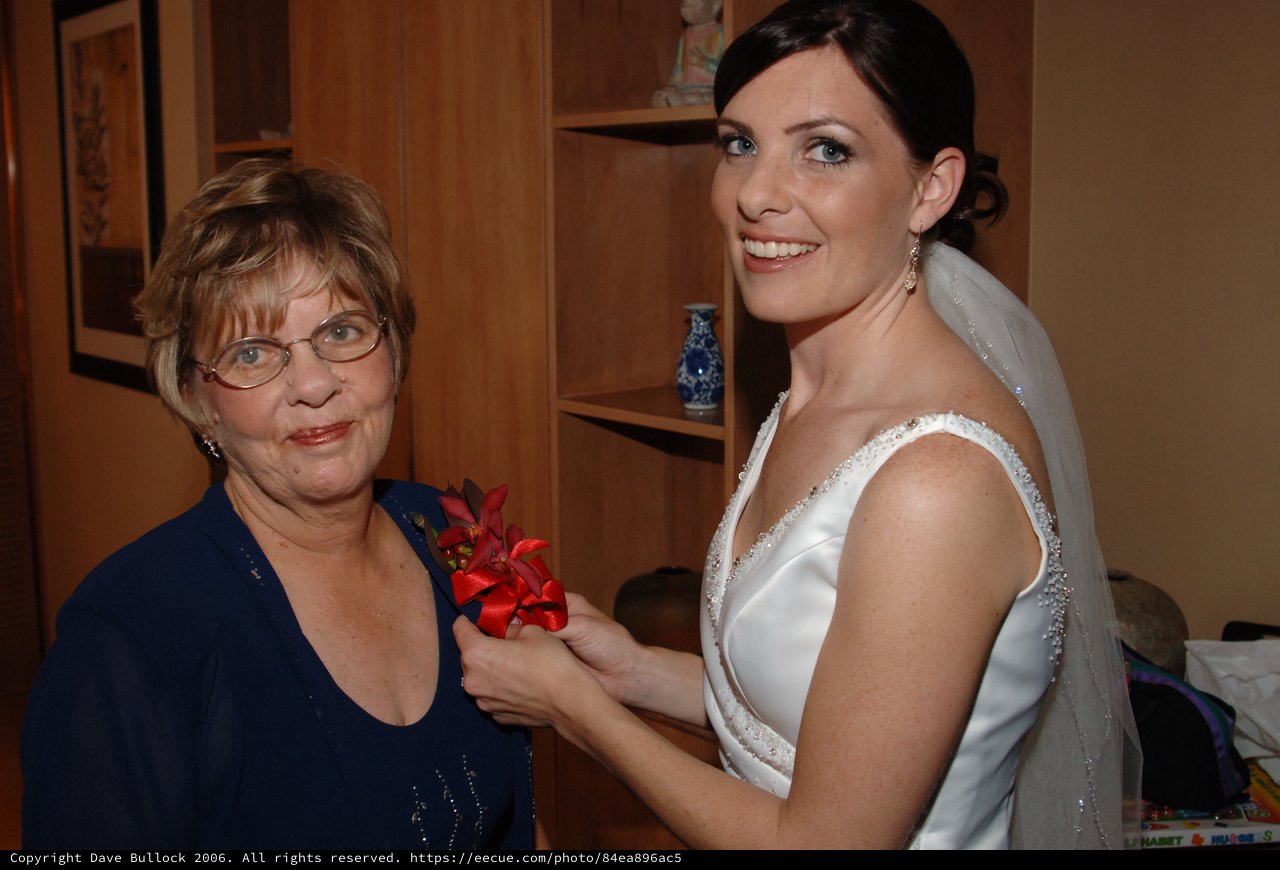 Bride Pins Corsage on Mother Before Wedding Ceremony