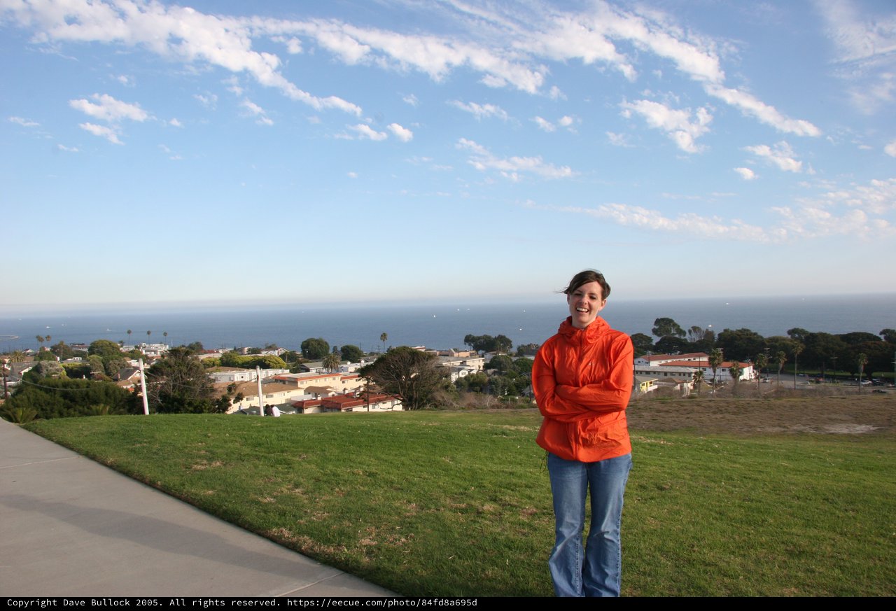 Woman in Orange Jacket Overlooking Coastal California Town