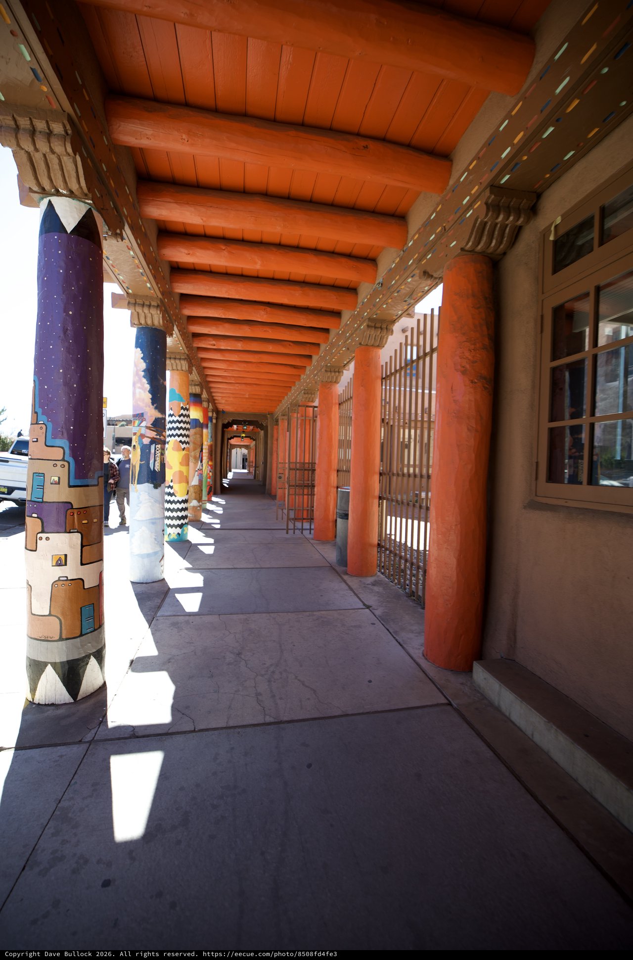 Traditional Adobe Covered Walkway with Painted Columns