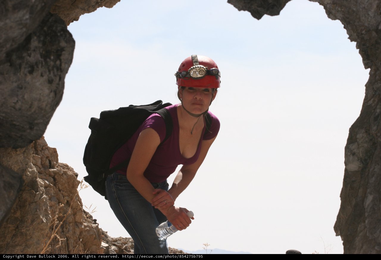 Cave Explorer Pauses at Rocky Arch Entrance