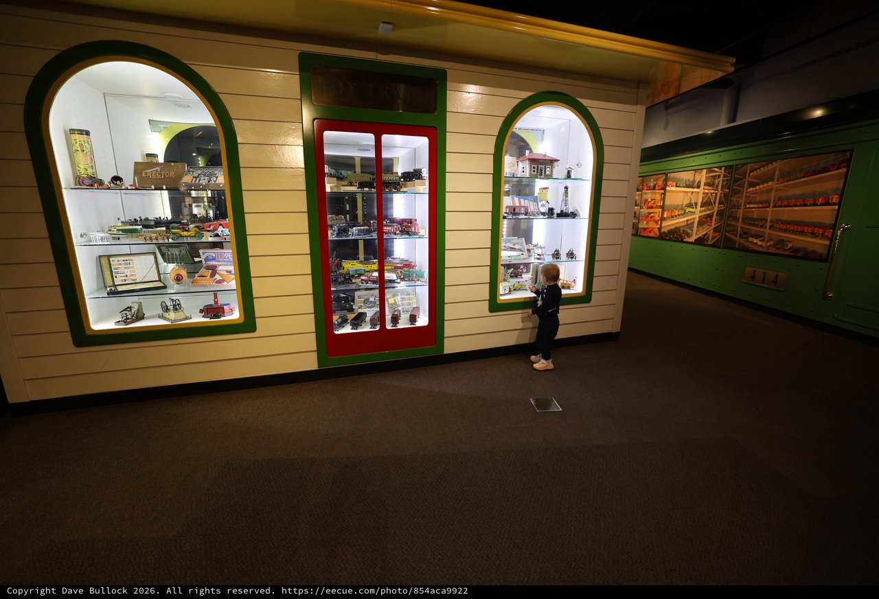 Young Visitor Explores Vintage Toy Display at Museum