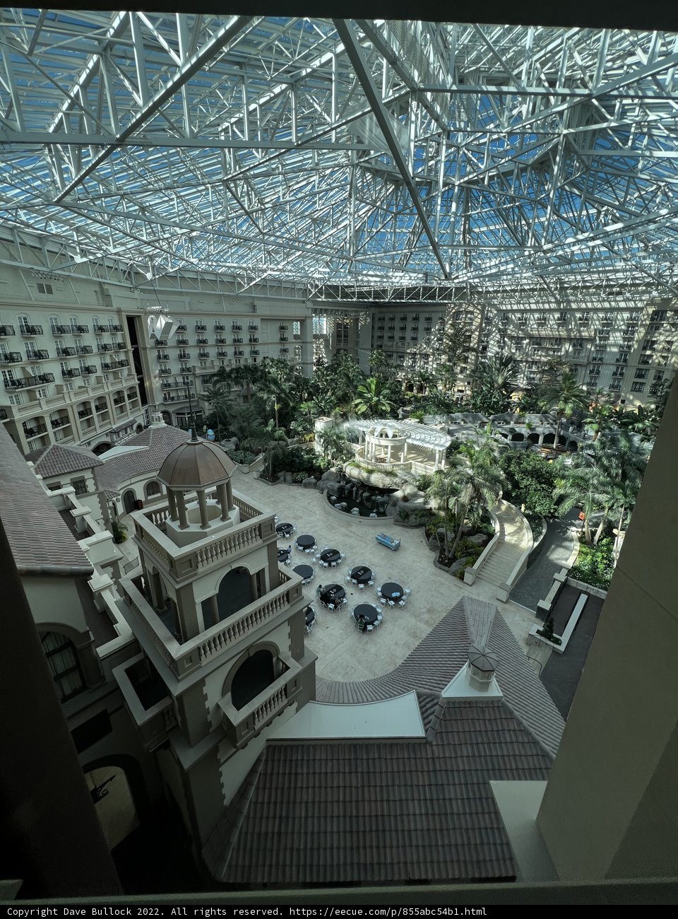 City Oasis Caption: The stunning atrium of the Westin St. Louis provides a refreshing escape from the bustling metropolis outside, with two towering office buildings framing the view. The skylight overhead illuminates a lush garden oasis with a swimming pool, potted plants, and elegant furnishings. A perfect spot for relaxation and rejuvenation in the heart of the city.
