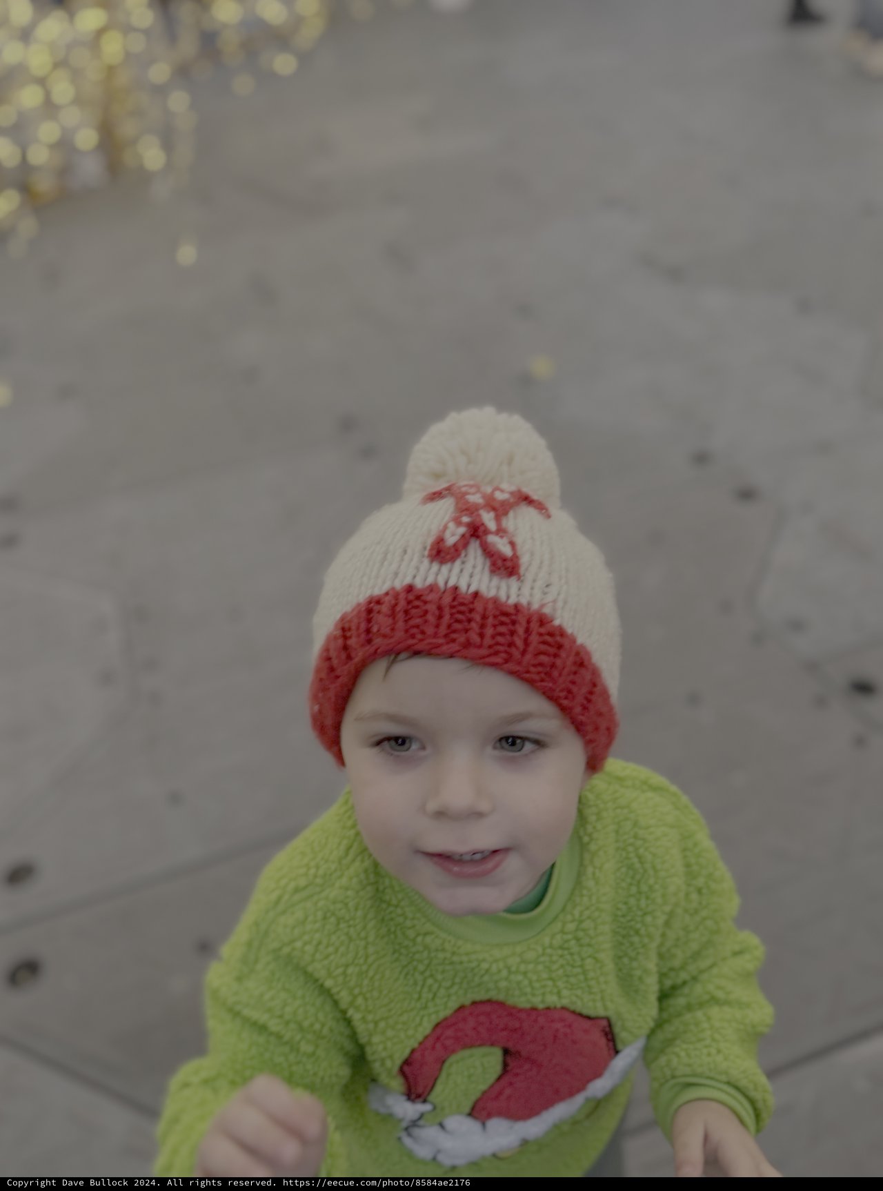 Child in Winter Hat Playing in Snow
