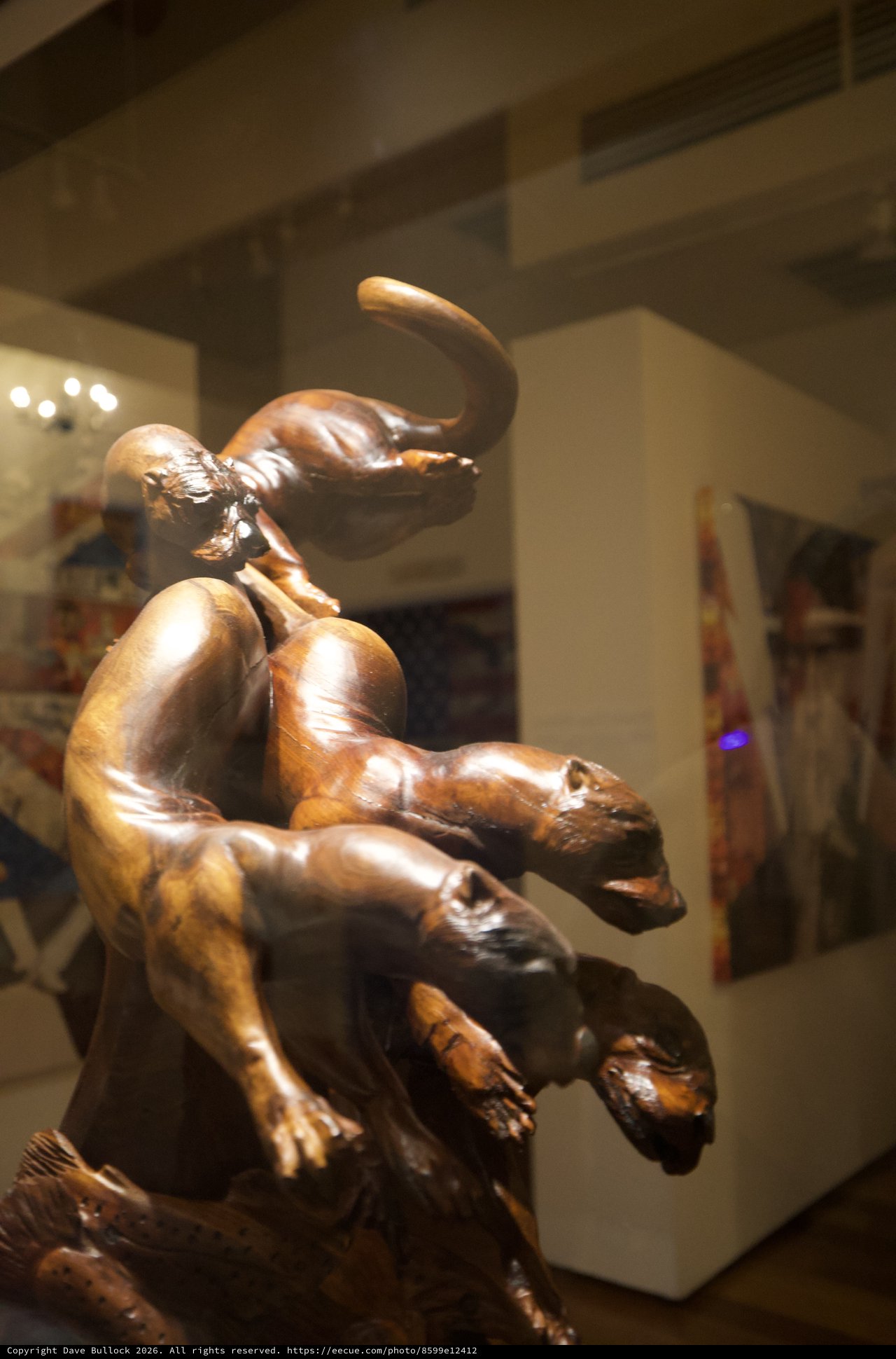 Bronze Sculpture of Playful Cats in Gallery