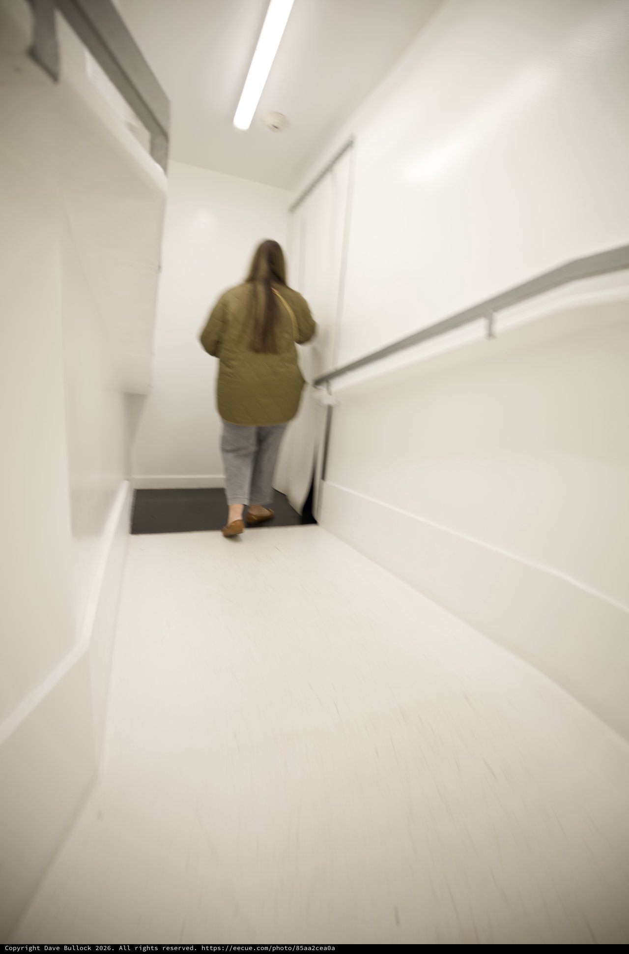 Woman Ascending White Modern Staircase in Minimalist Interior