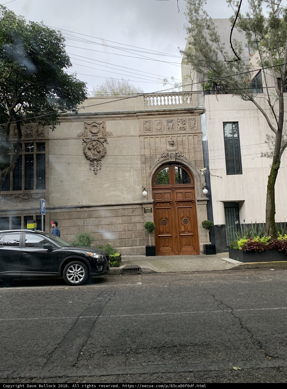Sporty Coupe Parked in Front of Historic Door