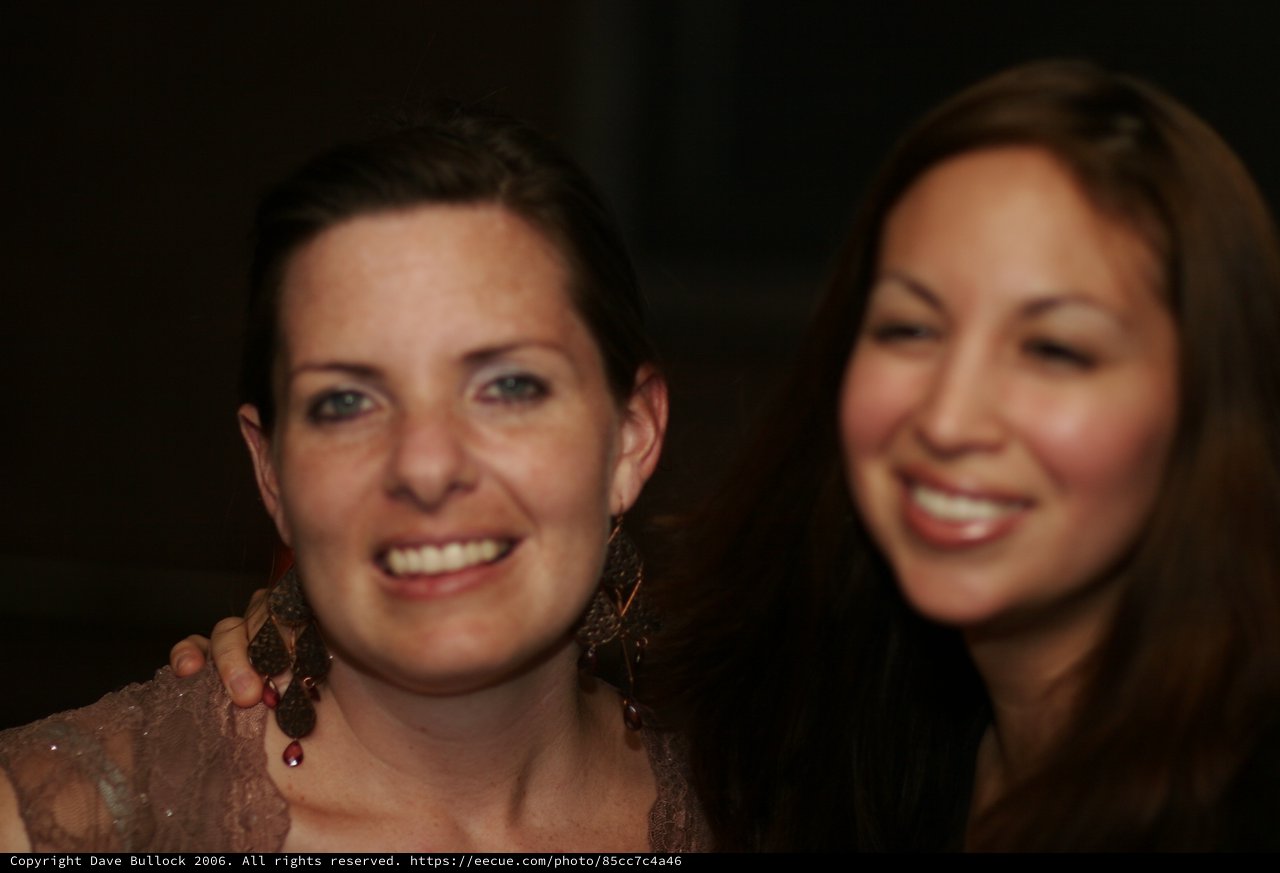 Two Women Smiling at Evening Celebration Event