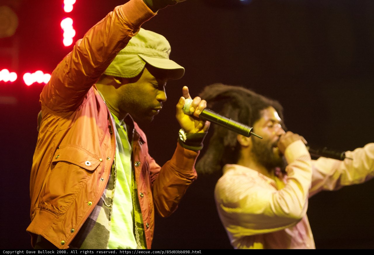 Two Entertainers Perform on Stage with Microphones