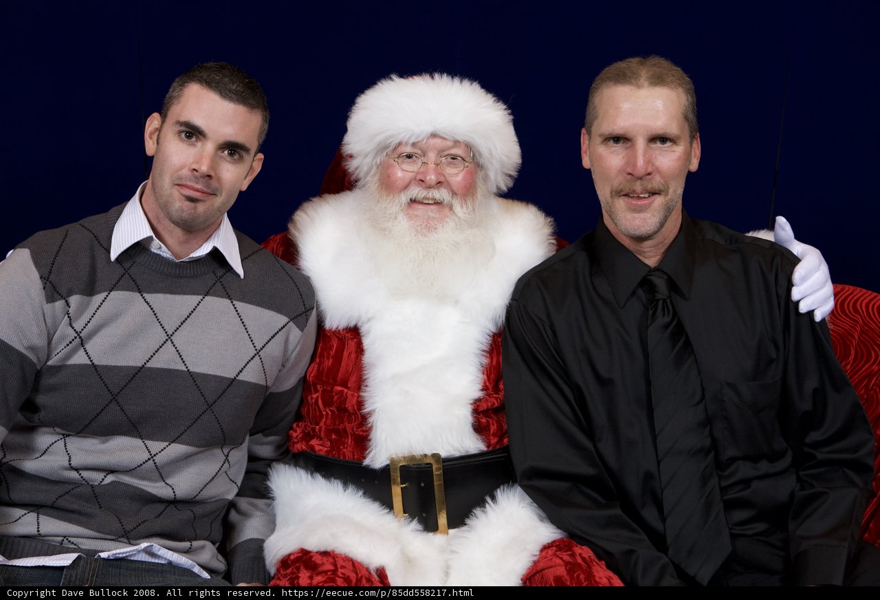 Three Men Posed with Santa Claus for Christmas Party