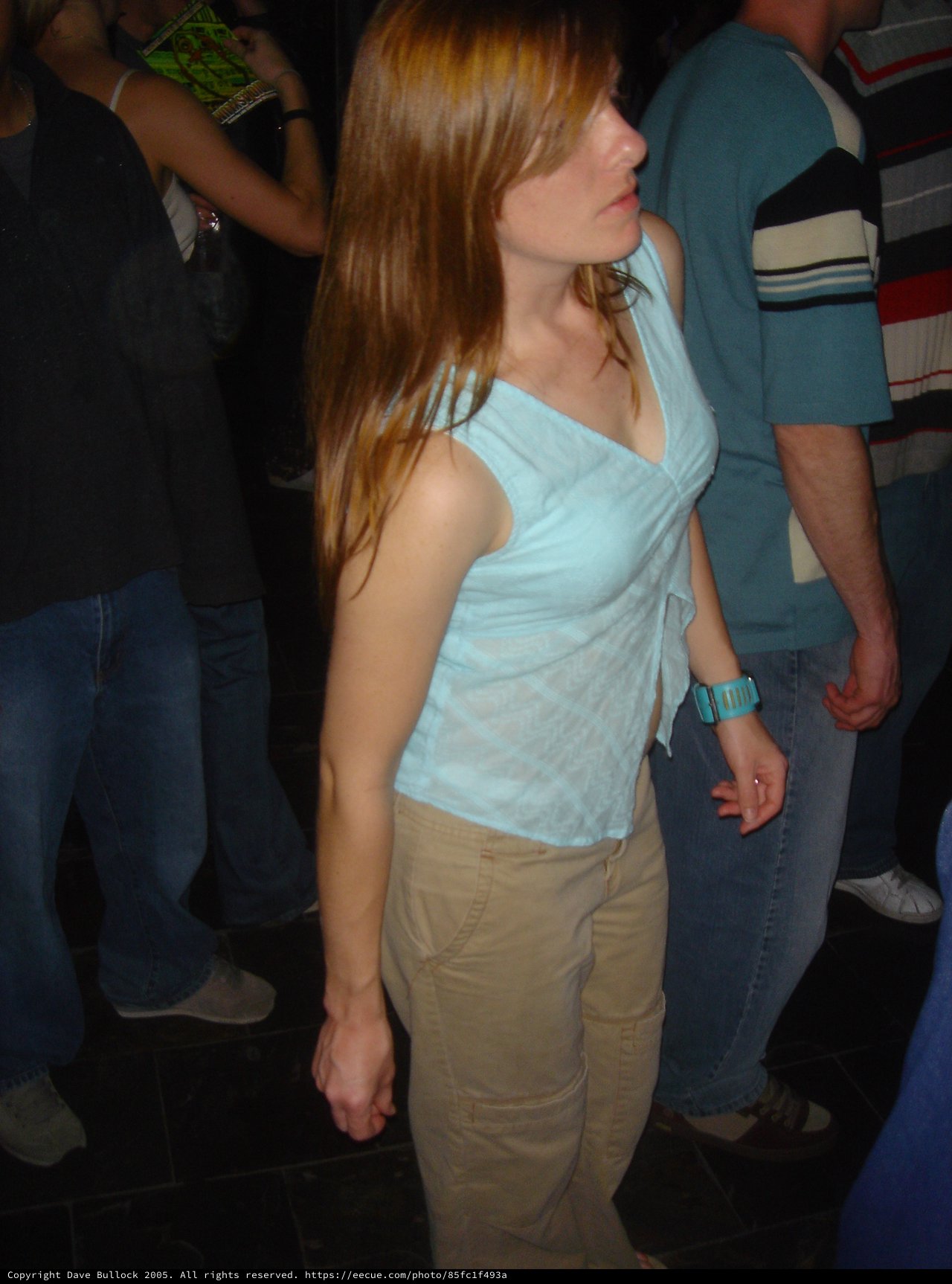Young Woman Dancing at Dimly Lit Nightclub