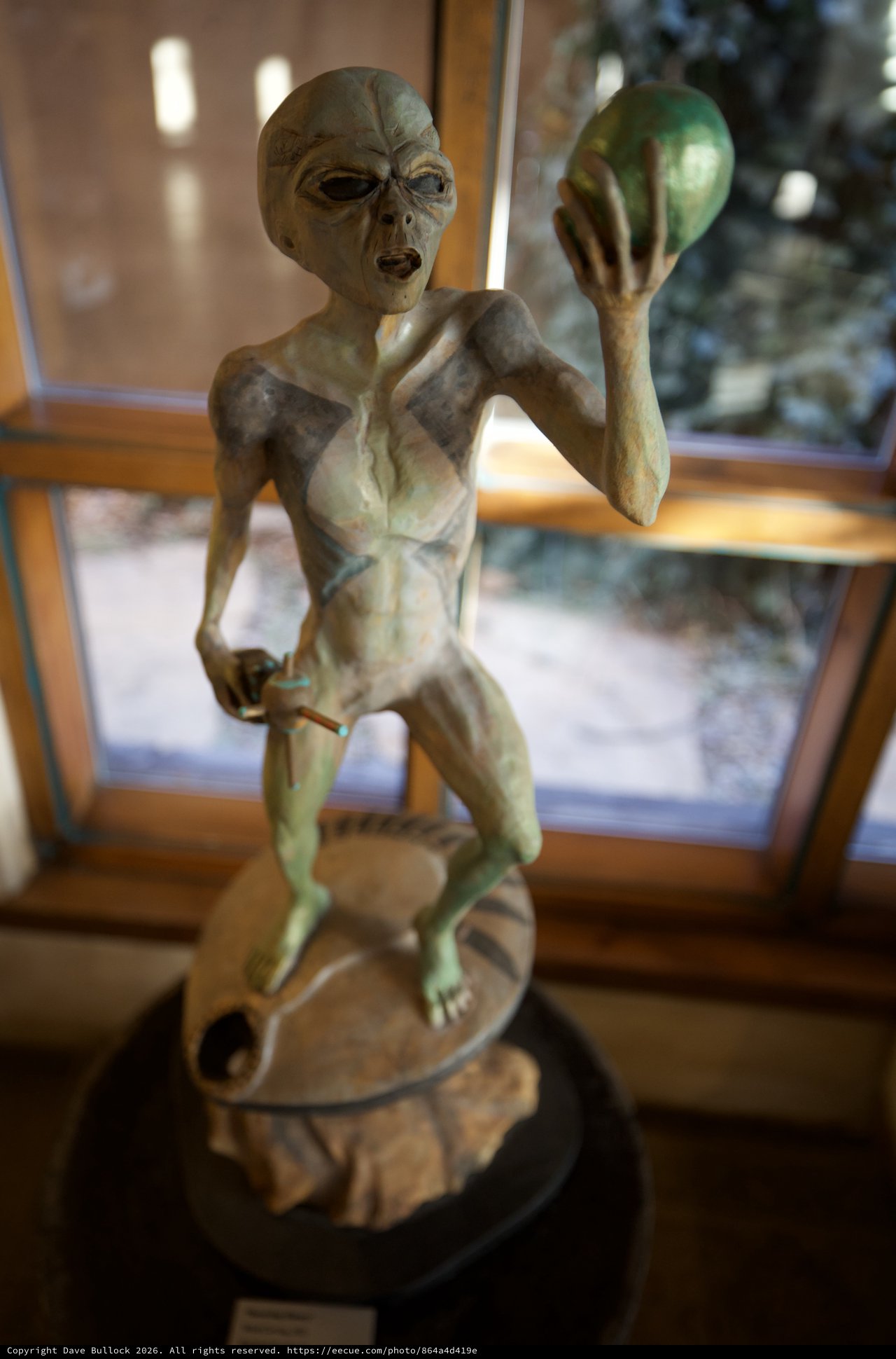 Alien Figure Sculpture Display in Interior Setting