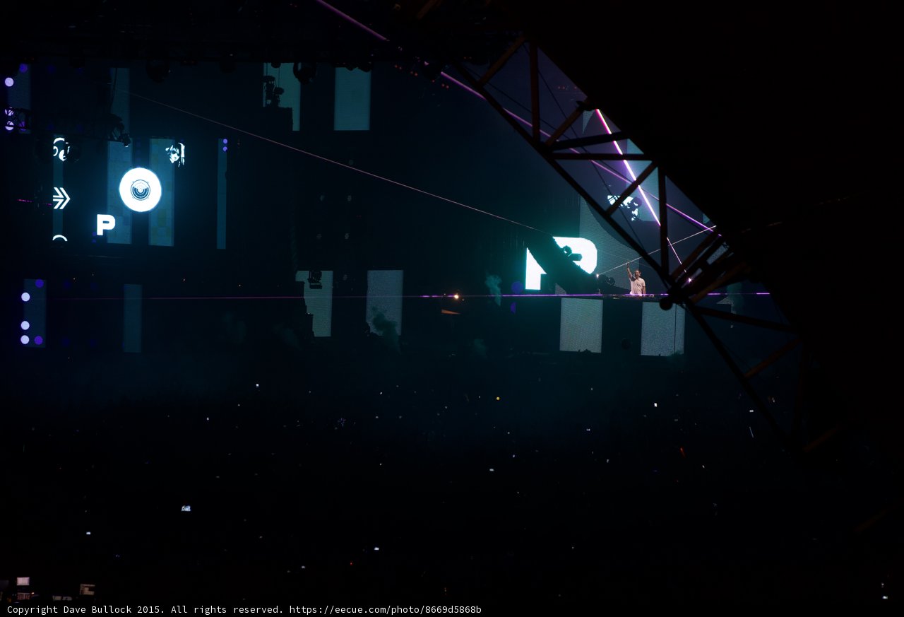 Lights Up the Night Caption: The massive screen and vibrant lights at the Coachella 2015 concert illuminating the crowds and energizing the atmosphere.
