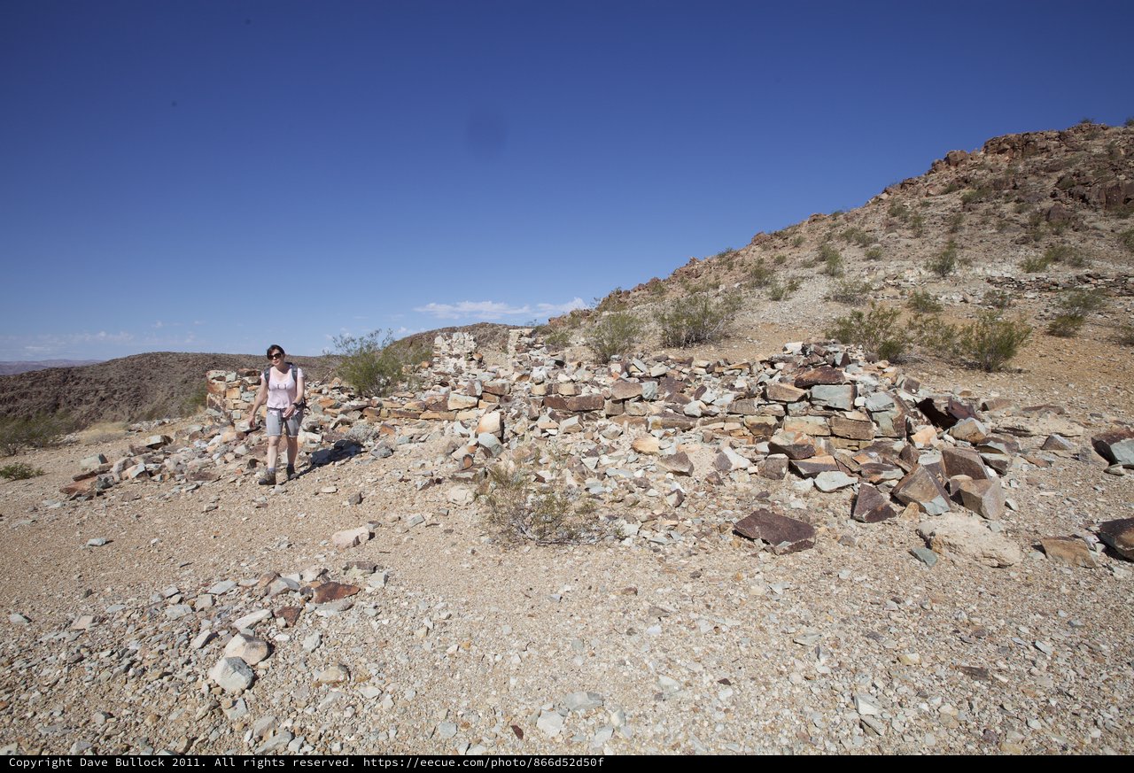 Explorer Among Ancient Desert Ruins on Rocky Ridge