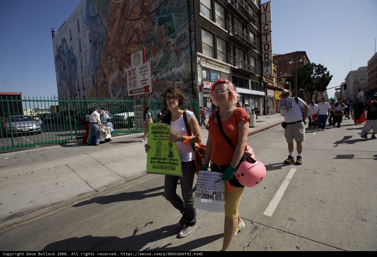 Woman Carrying Protest Sign at Mayday Rally