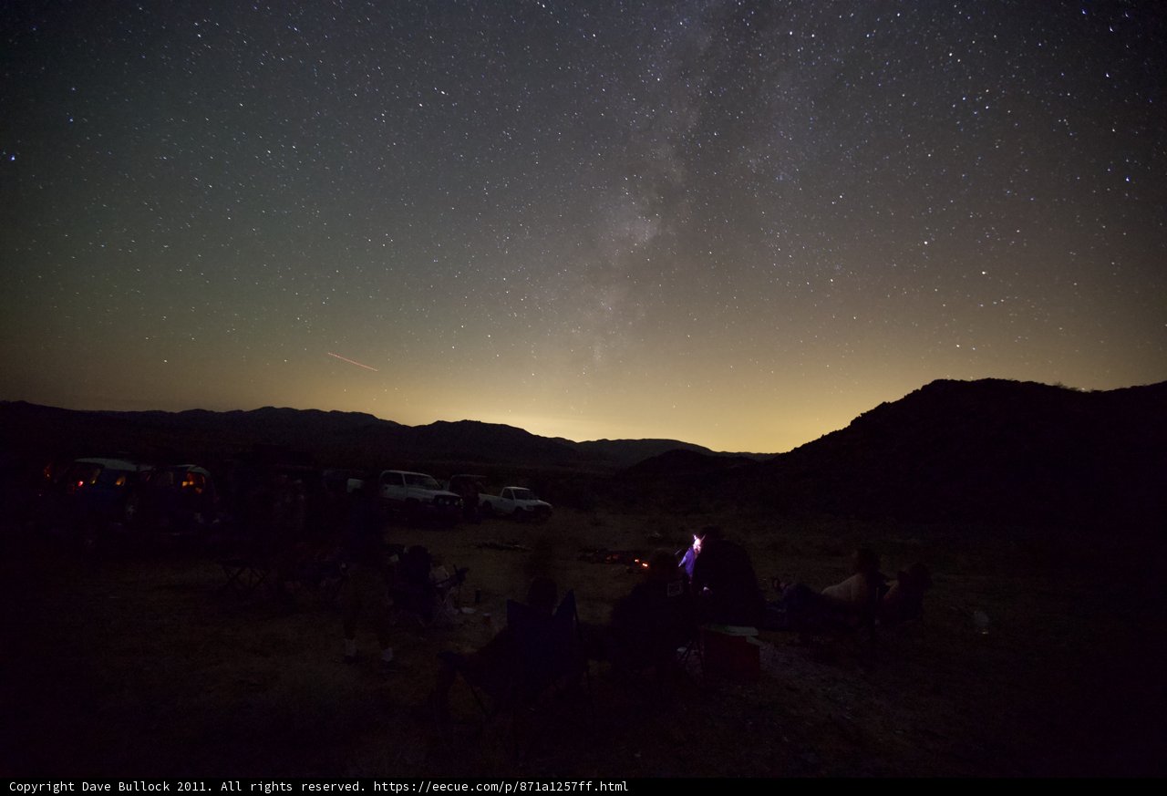 Under the Starry Sky Caption: Three people sitting around a campfire enjoying the beautiful night sky and scenery during a desert trip in October 2011.