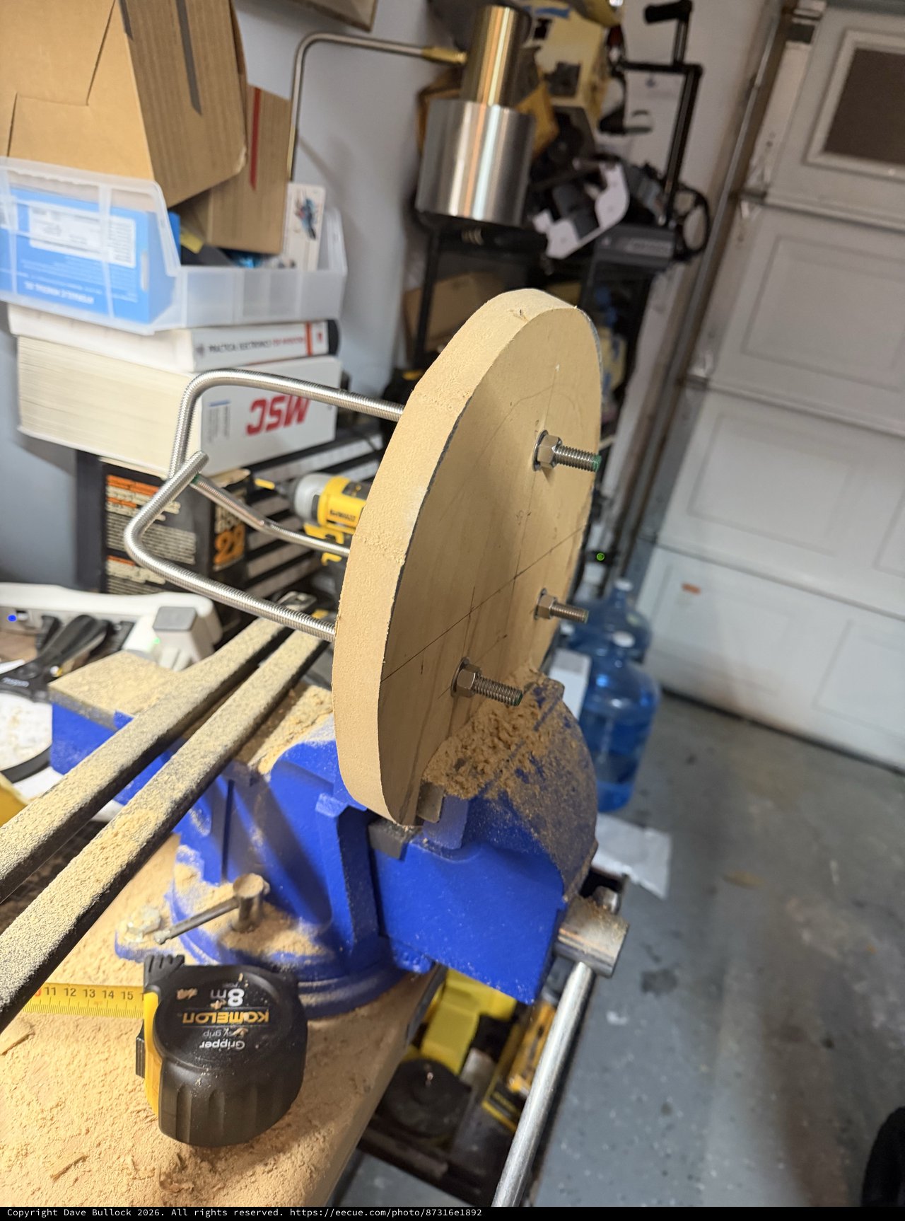 Wooden Wheel Secured in Blue Workshop Vise