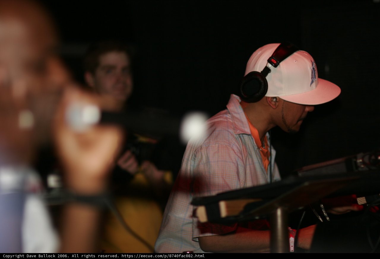 Man in White Hat Rocks Out with Headphones and Mic