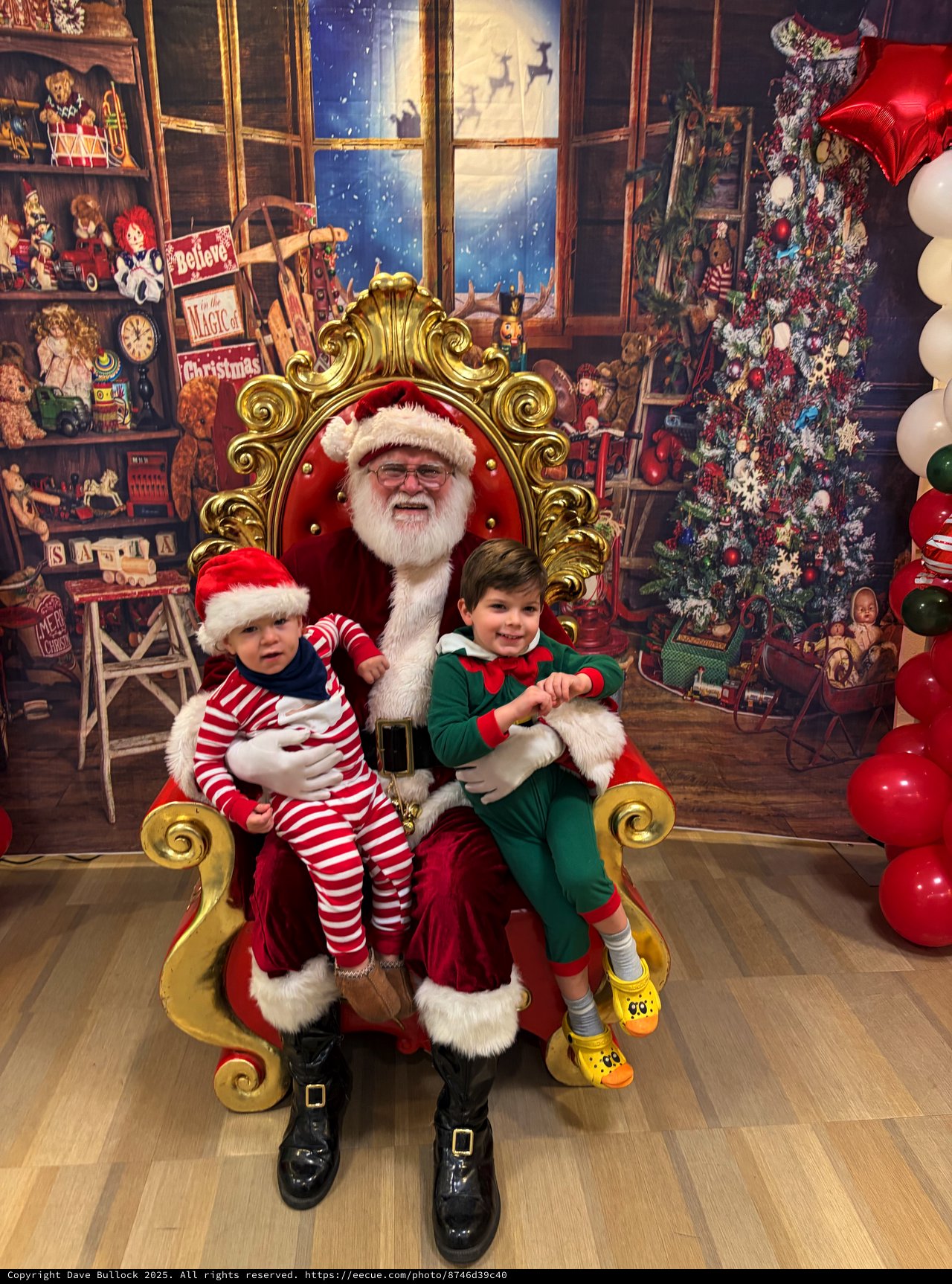 Two Children Visit Santa in His Festive Workshop