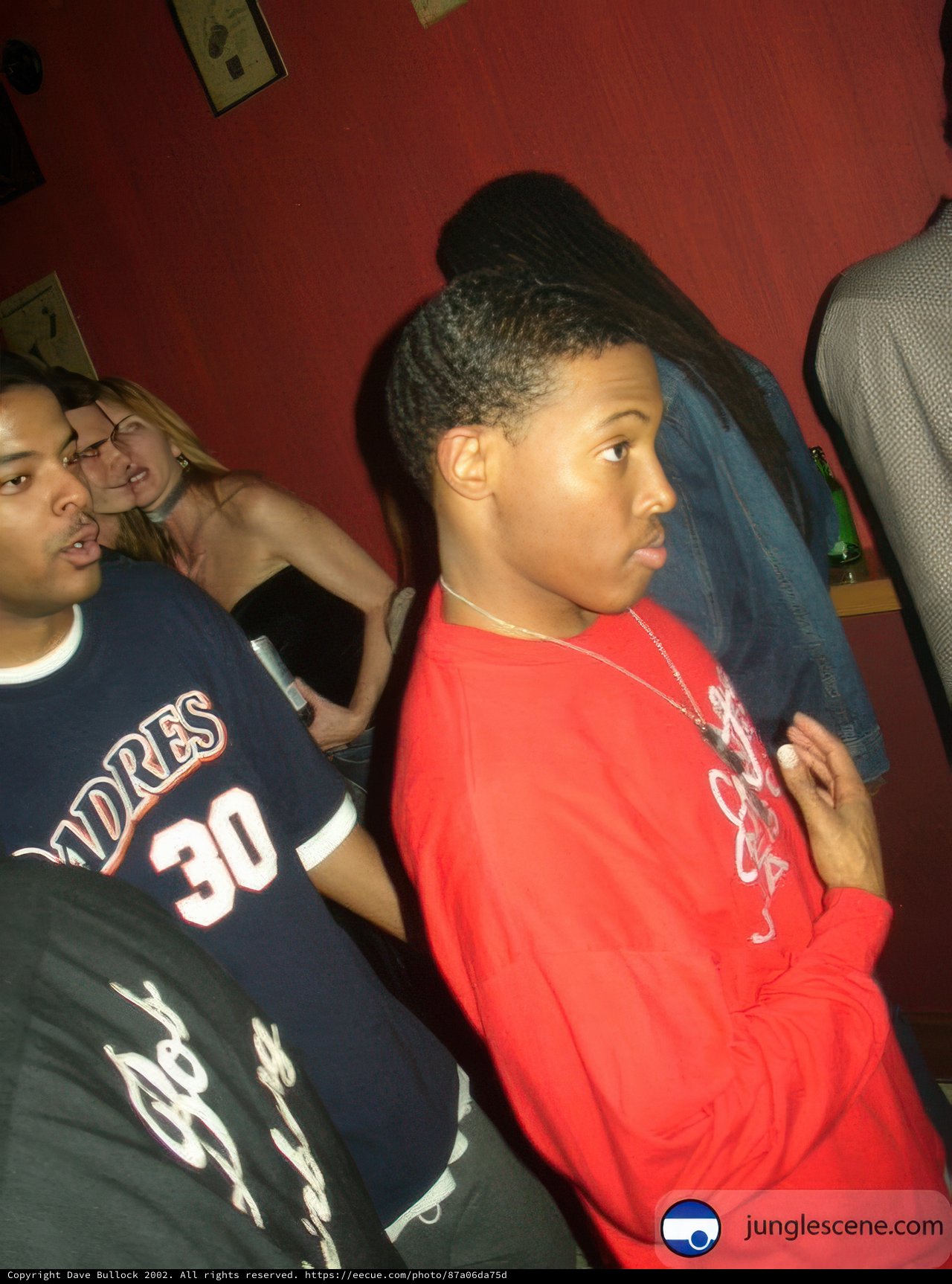 Red Shirted Man posing with Jewelry-wearing Boys