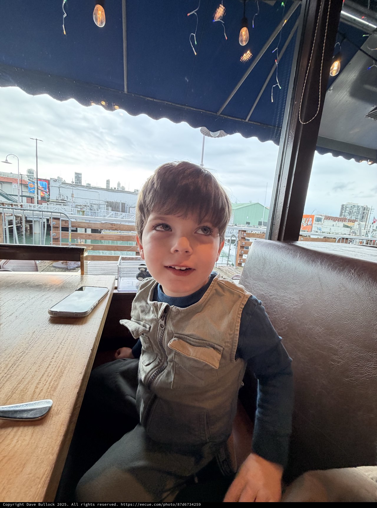 Young Boy at Rooftop Café with City View