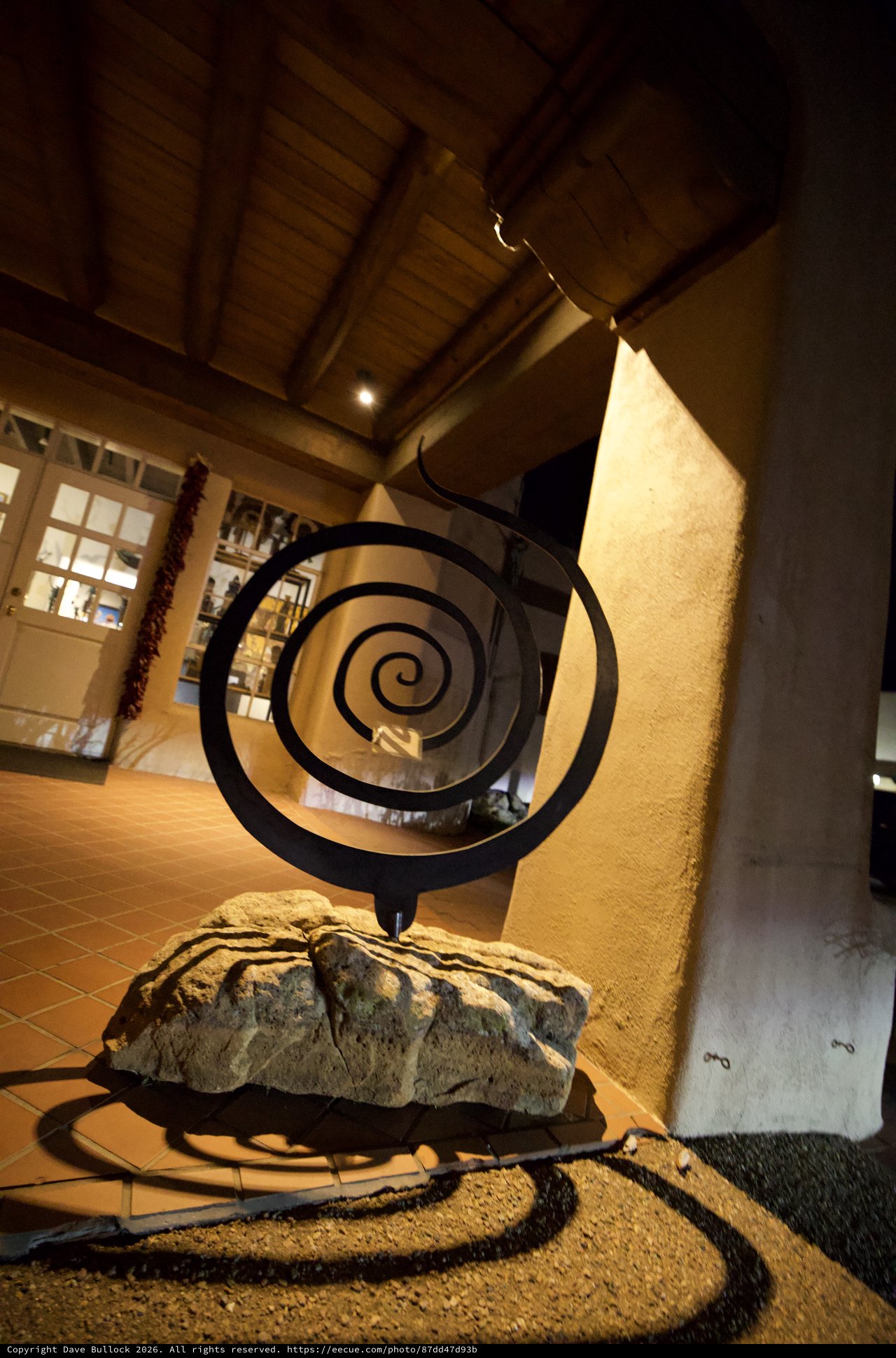 Spiral Sculpture in Warm-Lit Adobe Interior