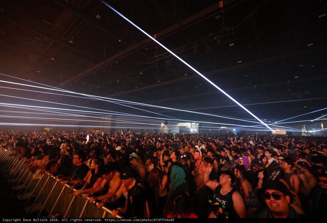 Massive Crowd Surges Under Laser Light Show