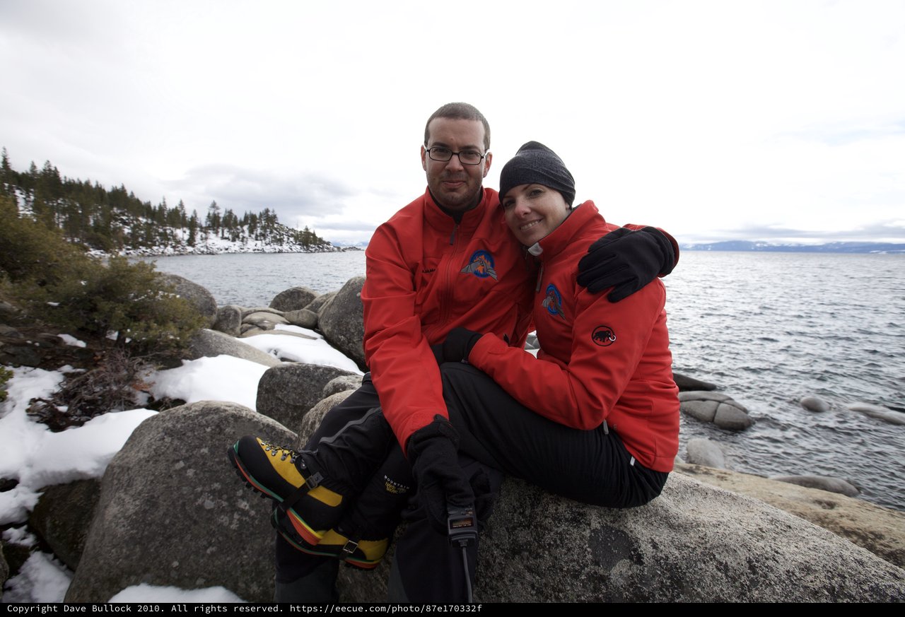 Couple Embracing by Snowy Lake Tahoe Shore