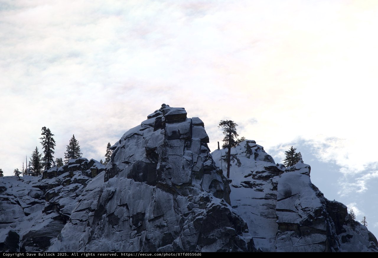 Rocky Summit with Snow-Dusted Evergreens at Dusk
