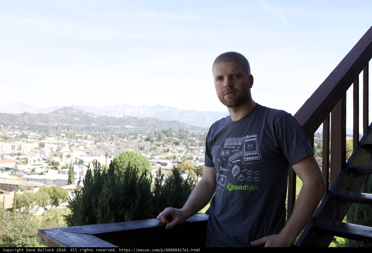 Man enjoying city skyline from deck