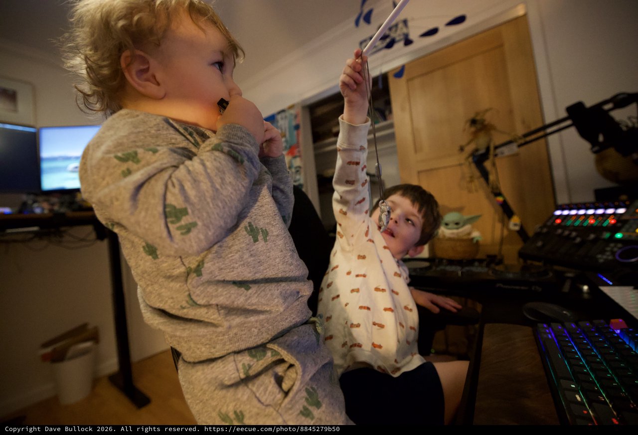 Two Children Playing at Gaming Setup in Pajamas
