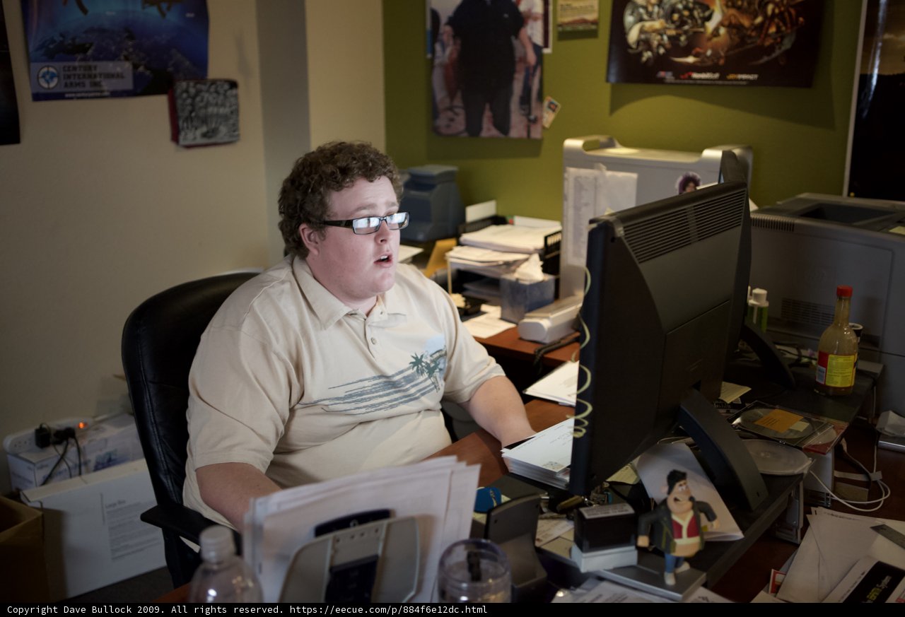 Man at Desk with Multiple Monitors