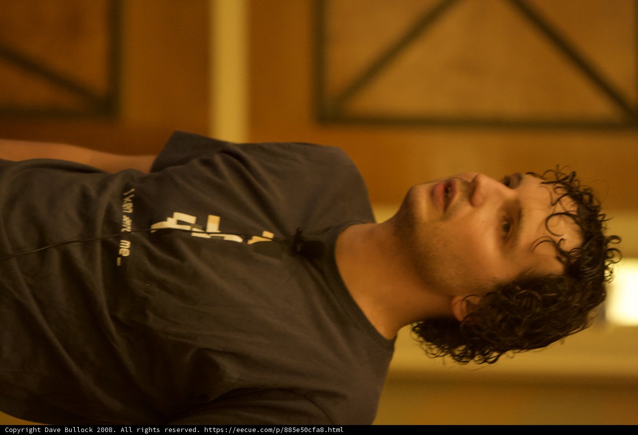 Curly-Haired Man in Black T-Shirt