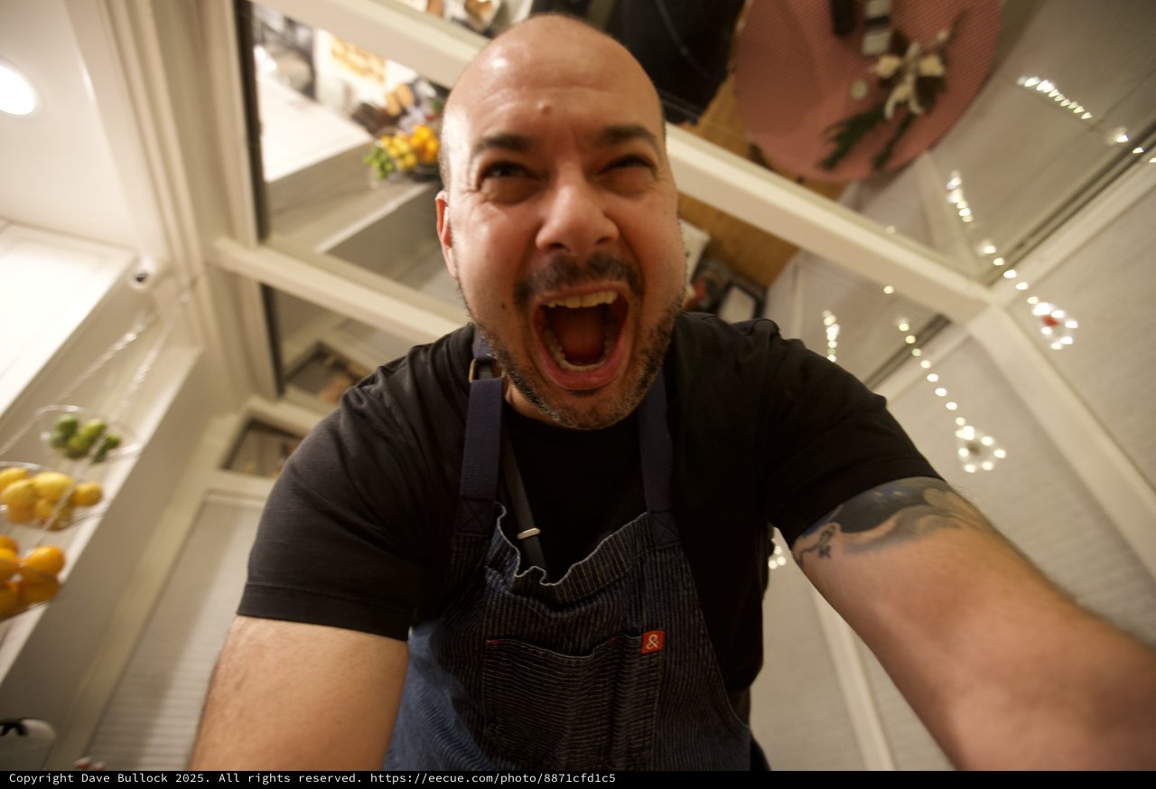 Exuberant Chef Takes Selfie in Modern Kitchen