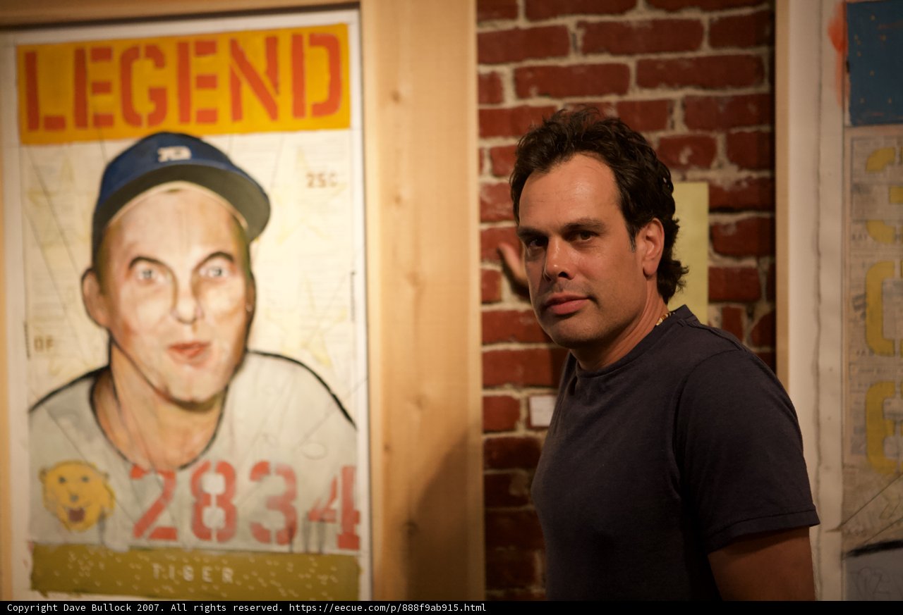 Baseball Fan Poses in Front of Player Poster