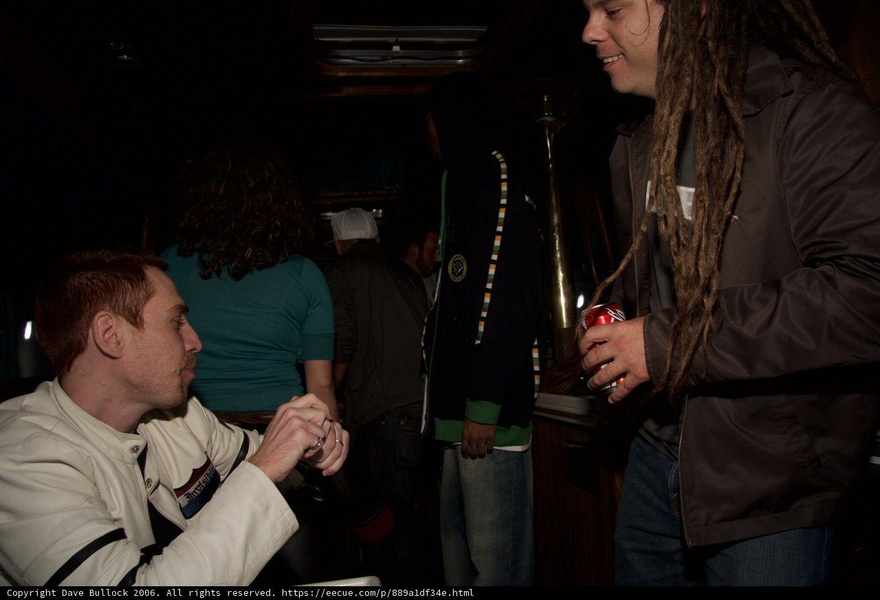 Man with Dreadlocks Enjoying Drinks with Friends at the Pub
