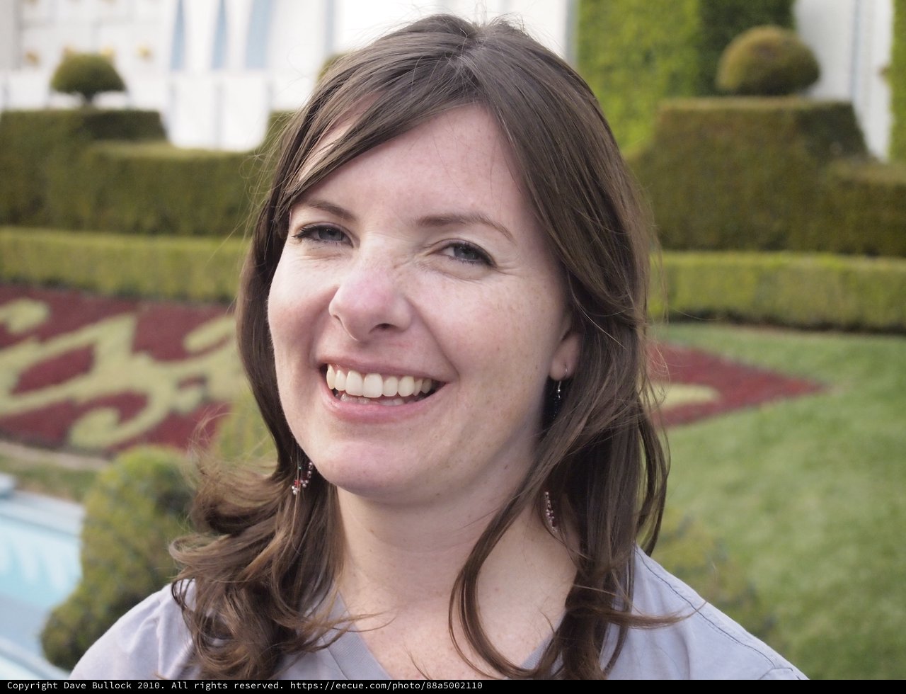 Joyful Woman Smiling at Formal Garden